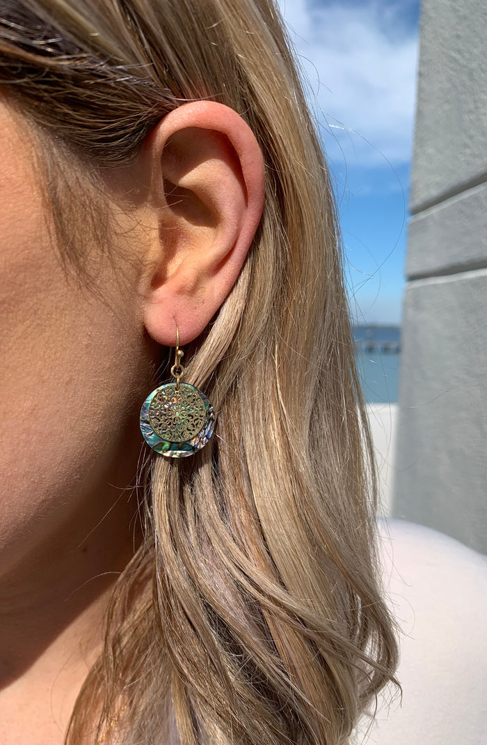Beth abalone earrings on model.