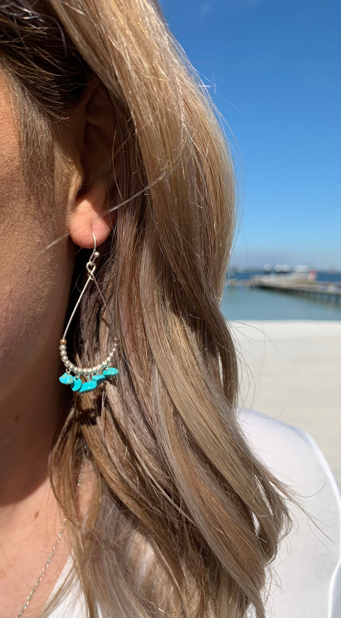 Brenda turquoise earrings on model.