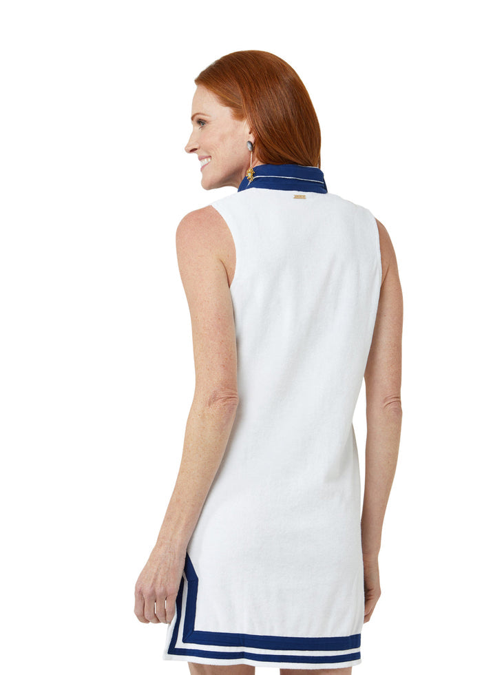 Woman wearing a white dress with navy trim on a white background