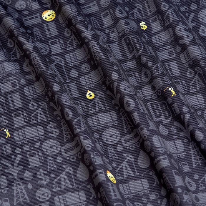 The Gusher - Polo features dark, folded fabric with gray oil rigs and barrels, scattered yellow emojis, an athletic fit, and moisture-wicking properties for all-day comfort.