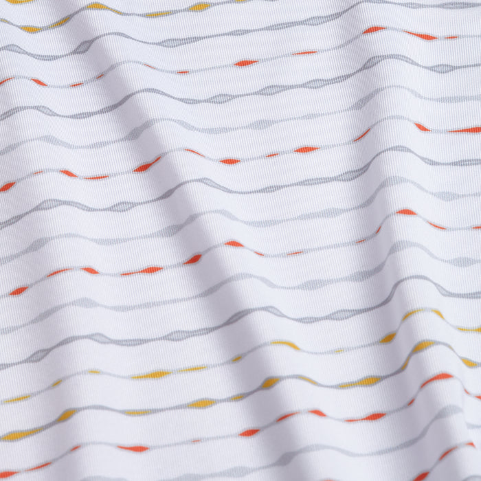 The Heat Index - Polo features white fabric with a subtle wavy texture, horizontal gray lines, and scattered orange, yellow, and red dashes. It offers UPF 50 protection plus an athletic fit with soft folds for a modern look.
