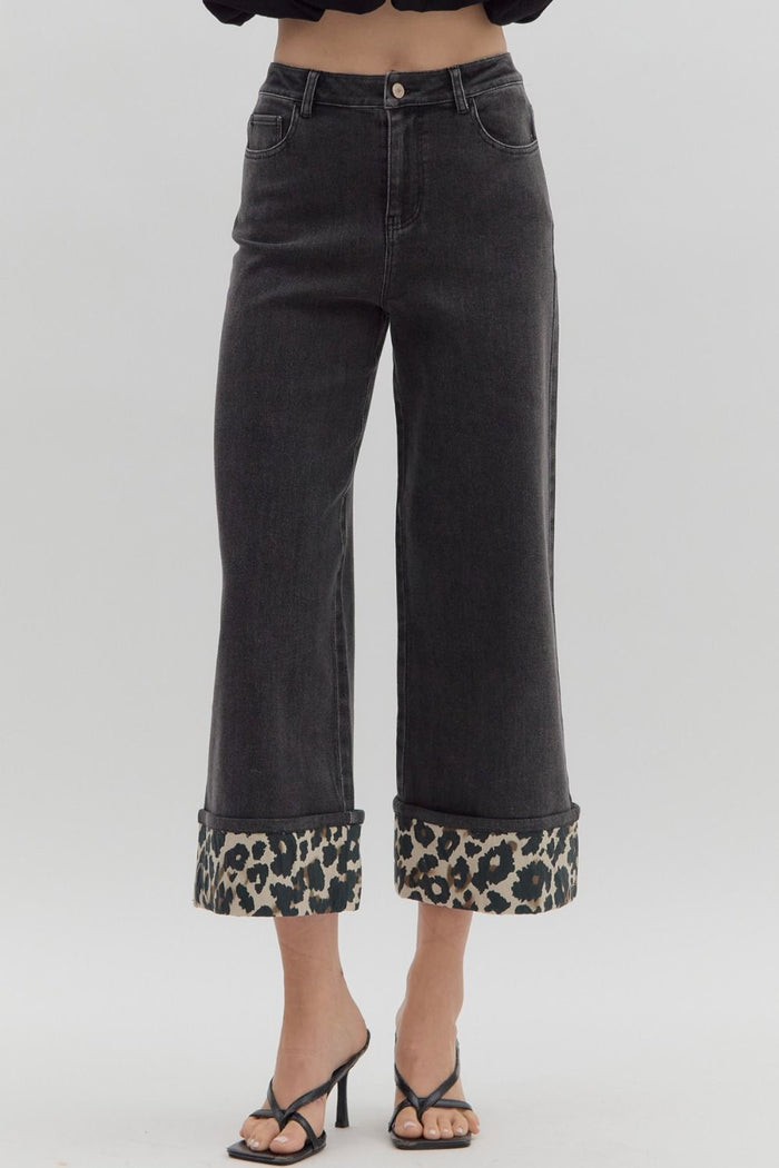 Black cropped wide leg denim jeans with a high waist and leopard print cuff detail.
