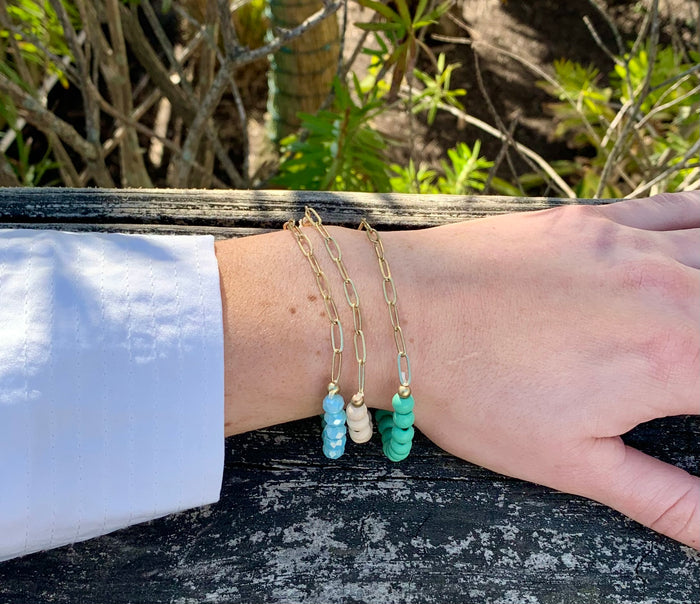 Pennie beaded bracelet/gold. Triple beaded chain bracelet with gold accent. Chain side on model.