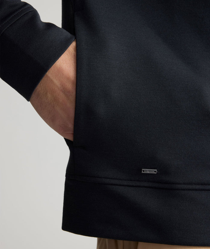 Model is wearing UNTUCKit Performance Mason Quarter Zip in Black.