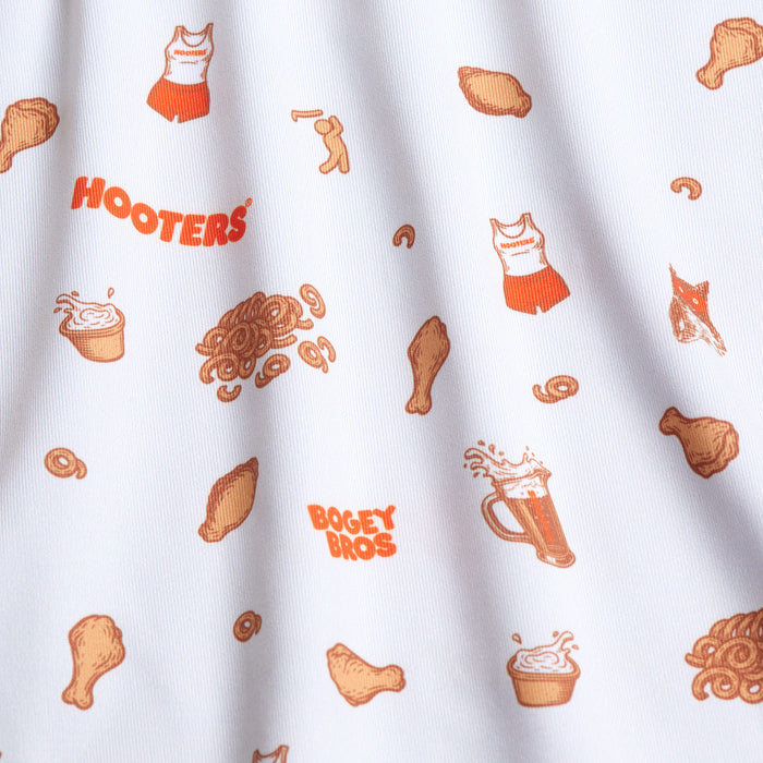 The Wingin' It - White - Polo is a white, moisture-wicking, UPF 50 shirt with a pattern of orange Hooters tank tops, shorts, chicken drumsticks, beer mugs, pretzels, cupcakes, and "HOOTERS" and "BOGEY BROS" in orange text.