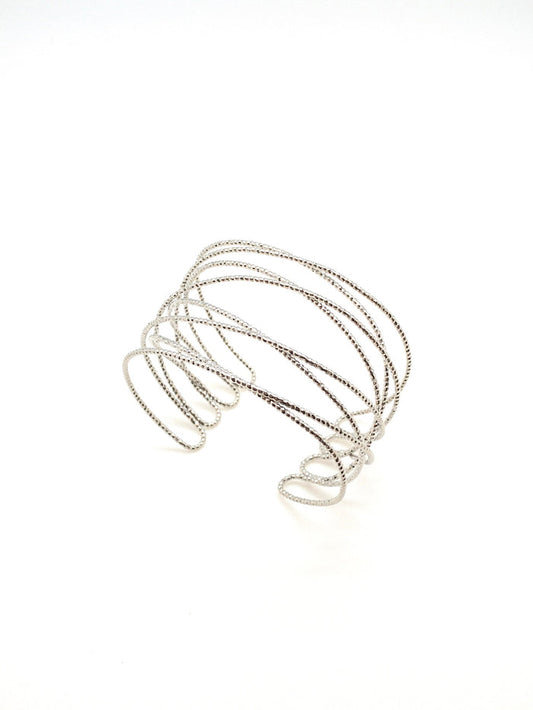 A silver-plated cuff bracelet with a diamond cut texture, displayed on a white background.