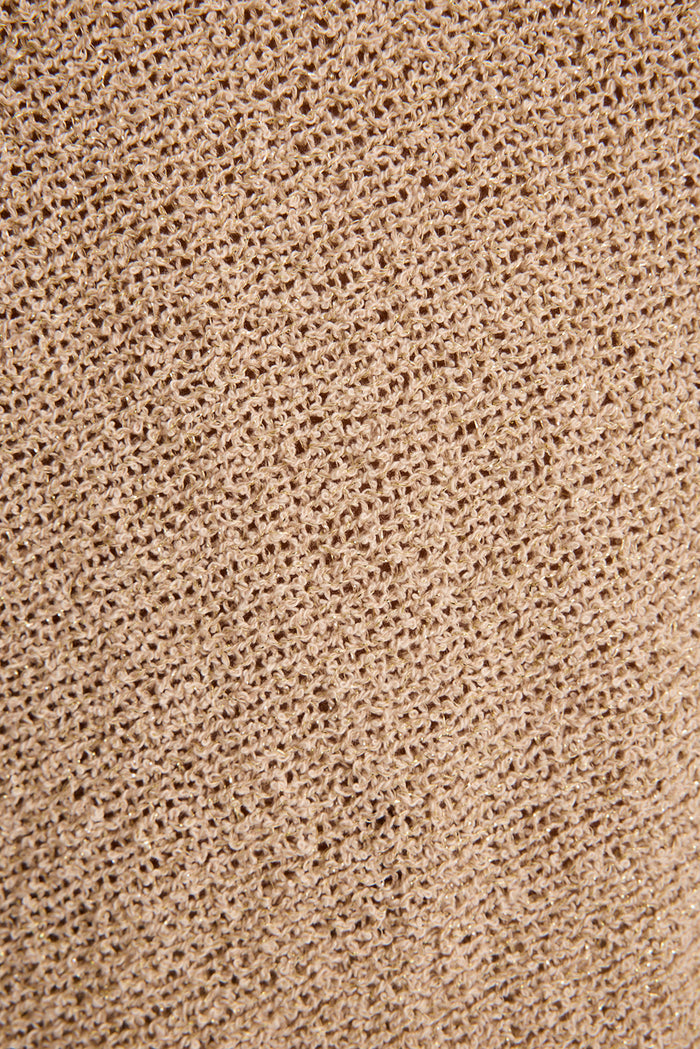 Close-up of stretchy metallic gold knit fabric used for the Avaiana festival shorts.