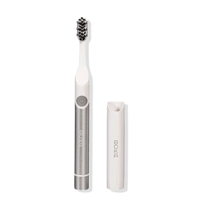 Boka Pocket Electric Toothbrush in silver with Sonic Pulse, white brush head, and travel cap.