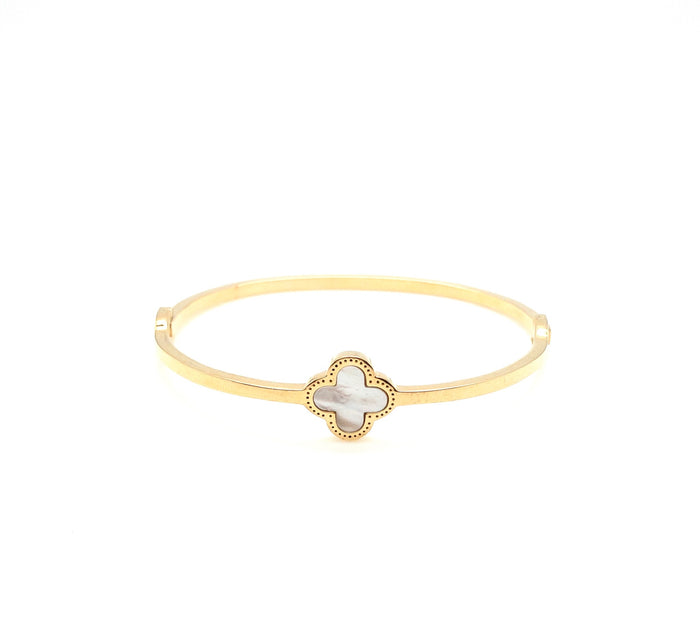 Gold cuff with a mother of pearl clover in center. Cecilia bangle