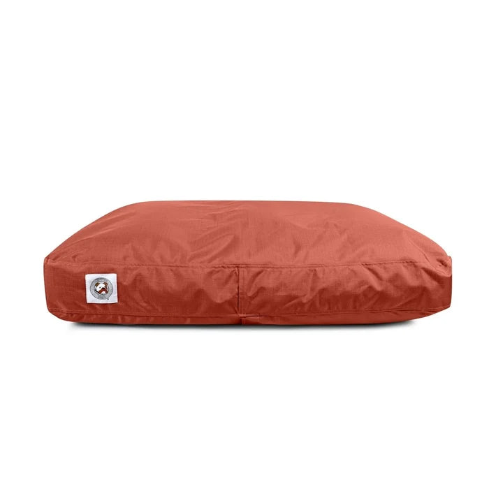 Red pet bed with a visible brand logo on a white background