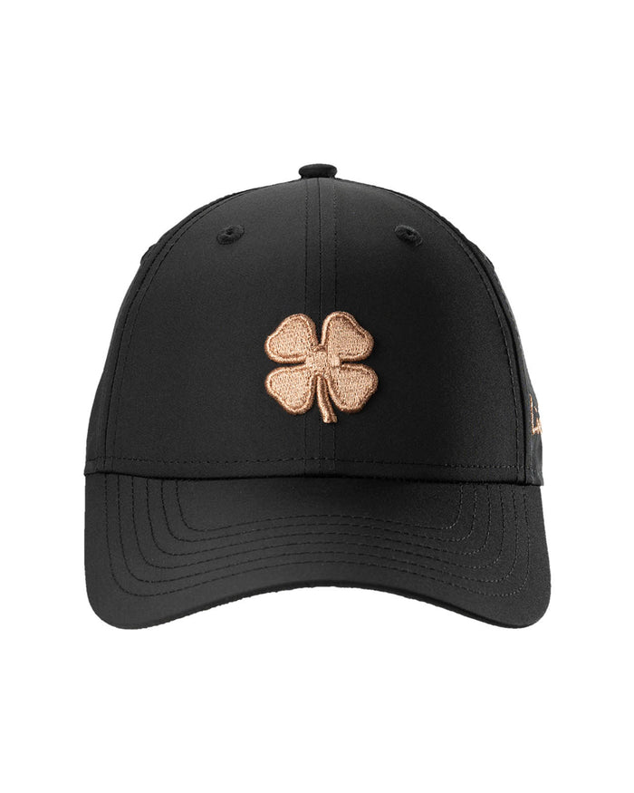 Black cap with a gold four-leaf clover emblem on a white background