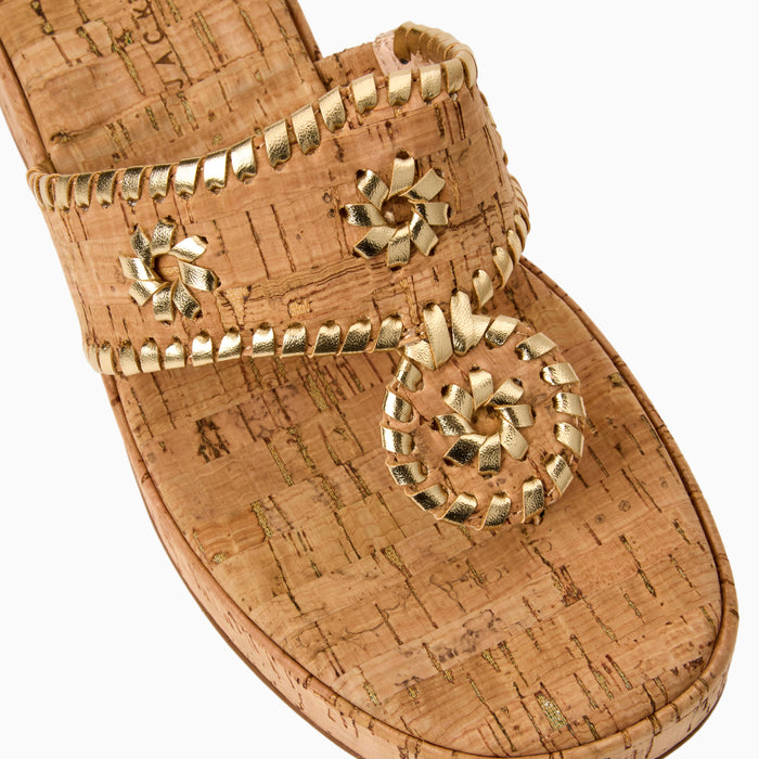 Cork sandal with gold embellishments on a white background
