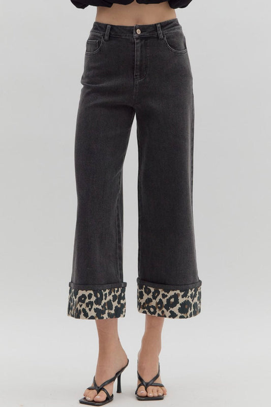 Black cropped wide leg denim jeans with a high waist and leopard print cuff detail.