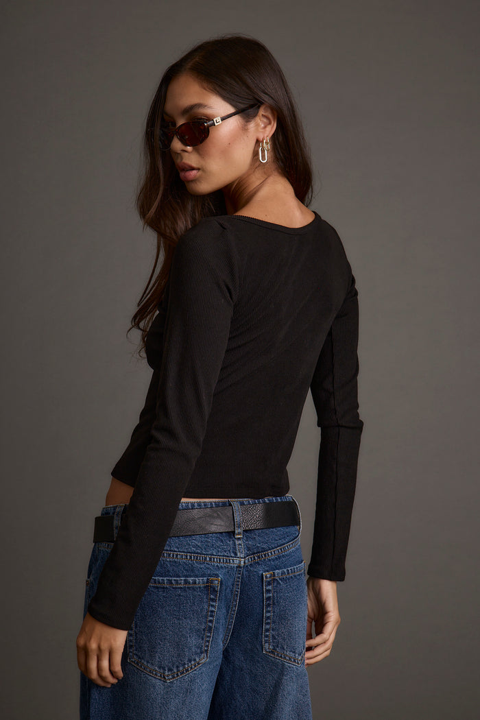 Back view of the black top showing the silhouette and fit.
