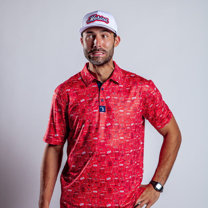 A man in a 'Merica - Red - Polo with athletic fit, a white Merica baseball cap, and a black wristwatch poses against a plain background, making an exaggerated funny face with raised eyebrows and lips pulled back.