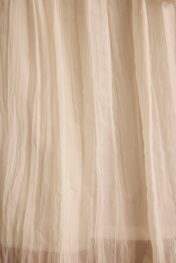 Close-up of the sheer crinkled ivory fabric on the Mischa resort wear shorts.
