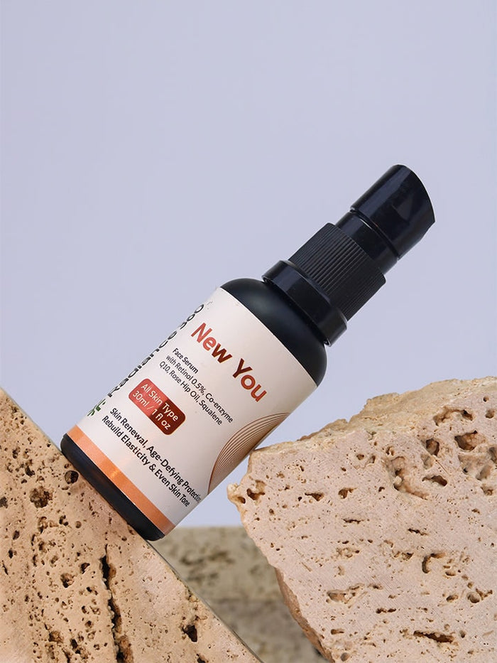 Skincare serum bottle labeled 'New You' with bread slices in the background