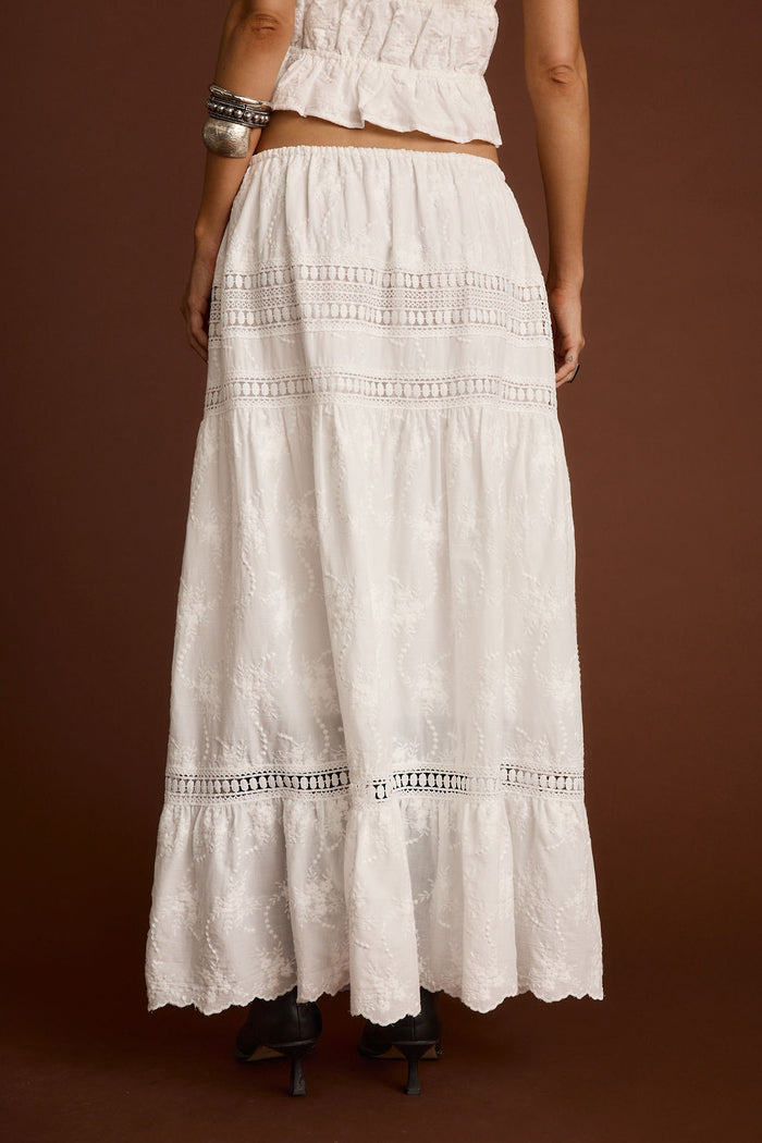 Back view of the white embroidered maxi skirt showing the silhouette and fit.