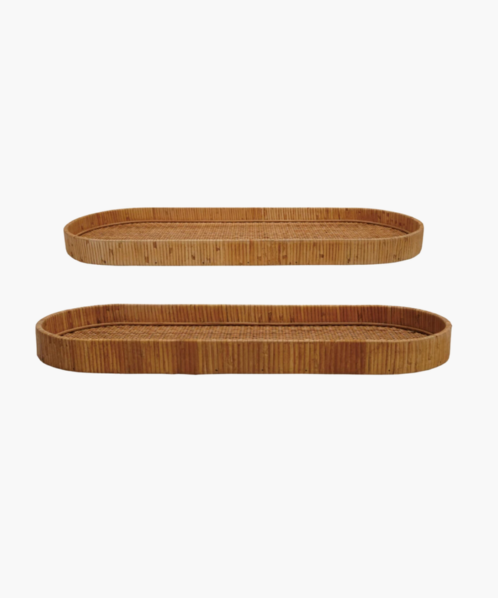 Two oval wicker handwoven trays with rounded edges, one smaller above the larger one, against a white background. Natural, rustic texture. | SW Home