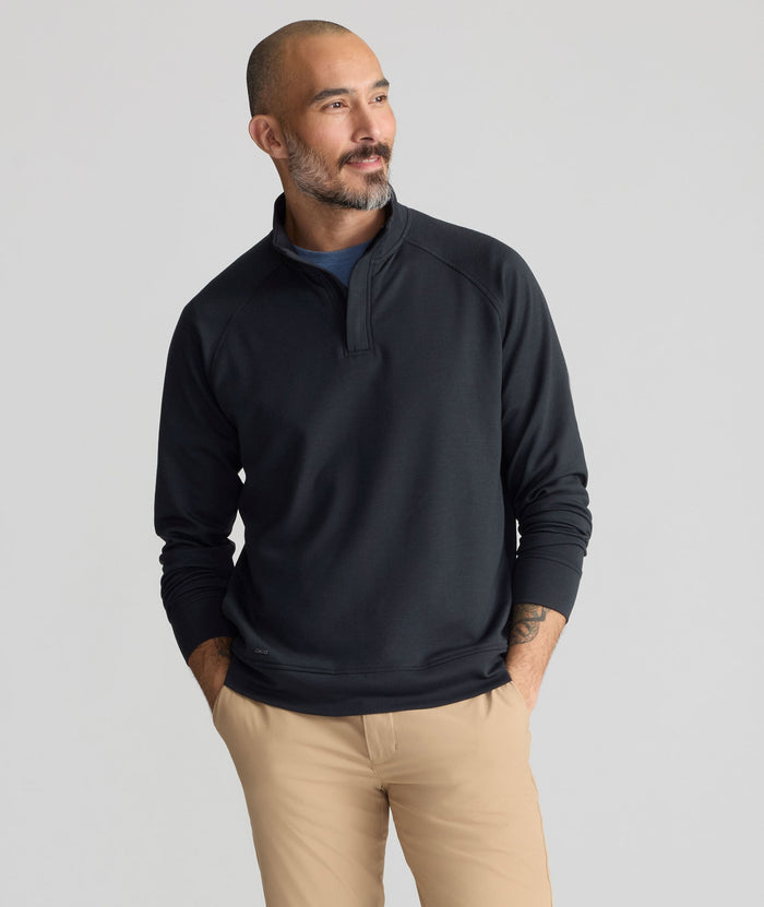 Model is wearing UNTUCKit Performance Mason Quarter Zip in Black.