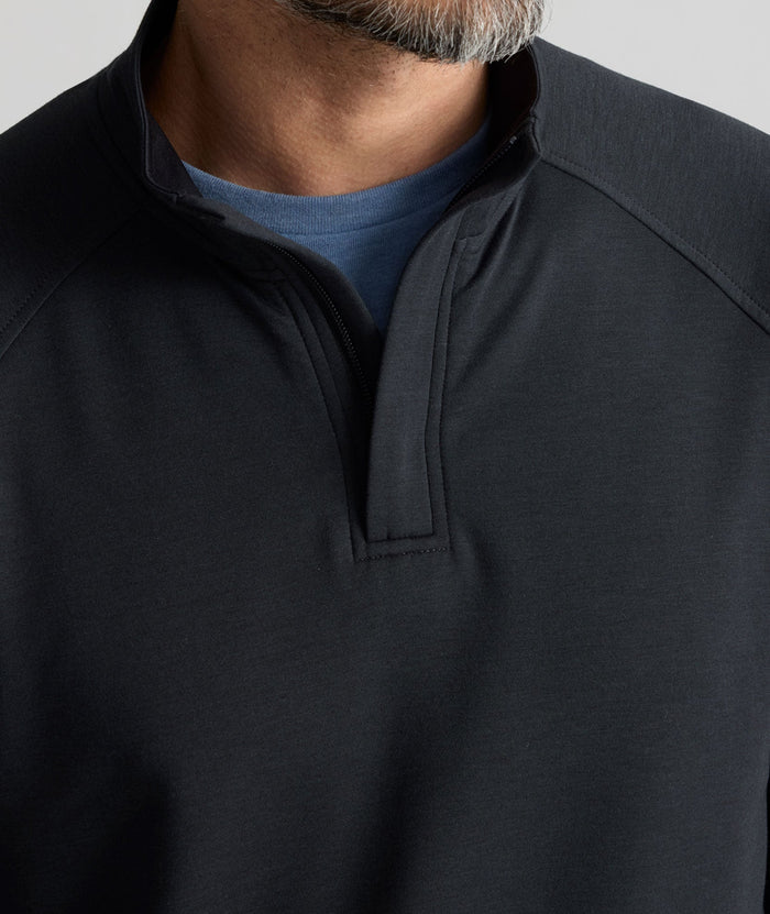 Model is wearing UNTUCKit Performance Mason Quarter Zip in Black.