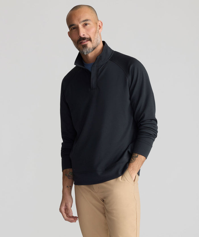 Model is wearing UNTUCKit Performance Mason Quarter Zip in Black.