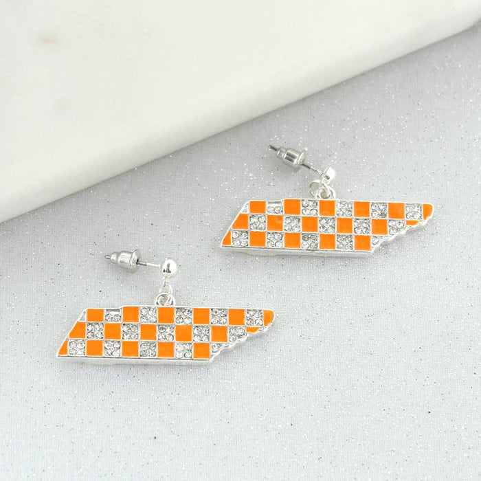 Pair of checkered flag earrings on a gray surface