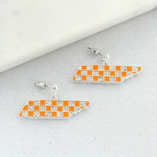 Pair of checkered flag earrings on a gray surface