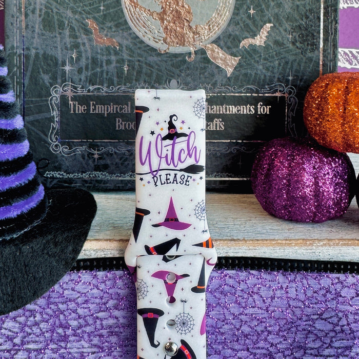 Close-up of the Witch Please Samsung Galaxy Watch band with the purple Witch Please lettering centered on the cream strap.